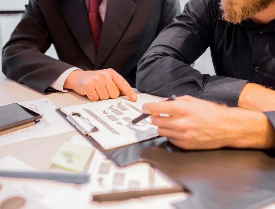 Two executives reviewing operating documents